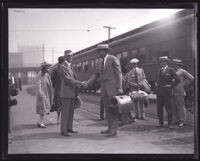 Arthur S. Bent shakes hands with Charles C. Teague at a train station, Los Angeles, 1920-1939