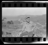 Doug Propst, head of Catalina Conservancy, standing on hill overlooking inlet of Santa Catalina Island, Calif., 1986