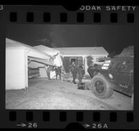 Scene of damaged house and Los Angeles police battering ram in Pacoima, Calif., 1985