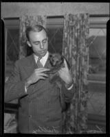 Louis J. Filley holds Kinkii, his Ecuadorian pet honey bear, in his home, South Pasadena, 1936