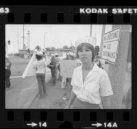 Women in sailor hats, demonstrating at Long Beach Naval Station in support of women sailors accused of homosexual behavior on the USS Norton Sound, 1980