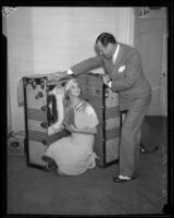 Cartoonist Sidney Smith and wife Kathryn Smith posing with trunk, [Los Angeles?], [1932?]
