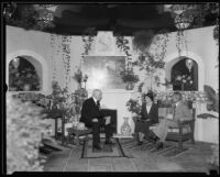 Three people sit in a display at the Los Angeles County Fair, Pomona, 1933