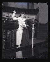 Aimee Semple McPherson speaking in front of microphone at Angelus Temple, Los Angeles, circa 1923