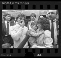 Ryan Thomas and parents outside courthouse after AIDS case verdict, Calif., 1986