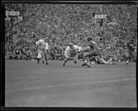 Trojan Grenville Lansdell runs for a gain of 25 yards against Duke in the Rose Bowl, Pasadena, 1939