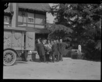 Pallbearers carry the coffin of Arthur Letts toward a funeral wagon at Holmby House, Los Angeles, 1923