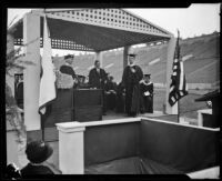 Rufus von Kleinsmid presents an honorary degree to Charles Wakefield Cadman at U.S.C. graduation ceremony, Los Angeles, 1926