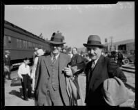 C. E. Newlin and J. E. Devirian at a train station, Los Angeles, 1927