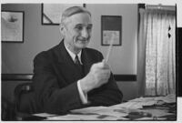 W. G. McAdoo seated at his desk, circa 1933-1938