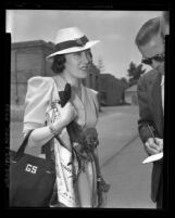 Actress Gloria Swanson talking to reporters as she arrives in Los Angeles, Calif., 1937