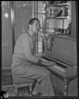 Peter Arno, cartoonist, playing a piano, 1927-1939