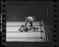 Referee administering a count during a Hank Hankinson boxing match, 1935