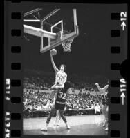 USC's John Lambert going up for a basket as Oregon's Stu Jackson watches during game in Los Angeles, Calif., 1975