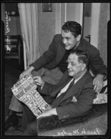 Charles Morton and Frank Mudge look at an advertisement for their vaudeville act, Los Angeles, 1935