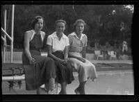 Elsie Kellogg, Jean Kennedy, and Elinor Jordan lounge on a diving board pool, Pasadena, 1935