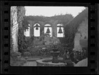 Visitors of Mission San Juan Capistrano sitting at a fountain, San Juan Capistrano, 1936