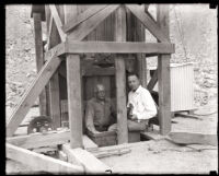 Two men standing at the construction site for the San Gabriel Dam, Los Angeles County, 1920s