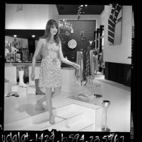 Model wearing vinyl dress at Paraphernalia boutique in Beverly Hills, Calif., 1967