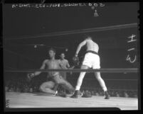 Boxer Billy Sexton falling to the mat after punches by Earl Ward in Los Angeles, Calif., 1948