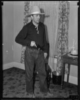 Dr. Ralph Wagner, extortion victim, posing with a gun in his home, Santa Clarita, 1935