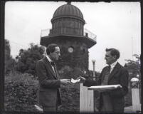 William A. Clark Jr. hands a check to composer Dane Rudhyar, Los Angeles, 1922