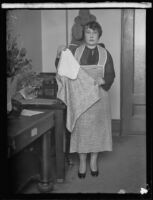 Unknown woman poses with evidence in the Aimee Semple McPherson kidnapping case, Los Angeles vicinity, circa 1926