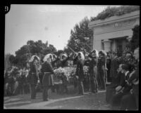 Members of the Knights Templar raise their swords above the casket of Arthur Letts in the Hollywood Cemetery, Los Angeles, 1923