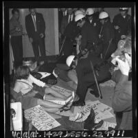 Police struggling with picketing CORE members in front of the Mayor's Office at Los Angeles City Hall, 1965