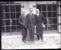 Rabbi Edgar F. Magnin, Dr. David W. Edelman, and Jack L. Warner standing in front of glass pane doors, Los Angeles, 1929