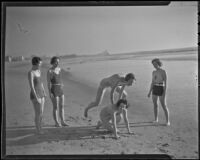 Mrs. W.R. Malcom, Elizabeth Scattergood, Mary McGeagh, Marcia Hammond, and Mrs. Calvin Wells Day (Esther Lynd Day Howard) play on the beach, Los Angeles, circa 1935