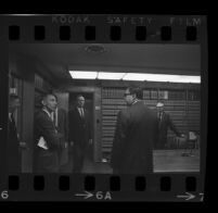 Jack Kirschke in a law office with five other men, Los Angeles, 1967