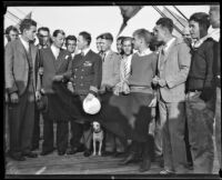 Commander Richard E. Byrd and his dog, Igloo, stand on the deck of the C. A. Larsen with a group of young men, Los Angeles, 1928