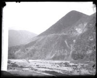 San Gabriel Canyon wall just before explosion during blasting excavation for construction of San Gabriel Dam, Los Angeles County, 1929