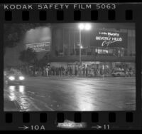 Line of people waiting outside movie theatre to see "Beverly Hills Cop" in Los Angeles, Calif., 1984