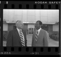 Ivan Houston and Larkin Teasley of Golden State Mutual Life Insurance Co. standing before company's building in Los Angeles, Calif., 1984