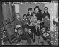 Lieutenant Virginia White poses with several children at a Salvation Army Christmas party, Los Angeles, 1935