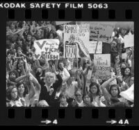 High school students with placards demonstrating over funding of athletic programs outside the Los Angeles Board of Education, Calif., 1980