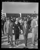 Actress Marilyn Monroe walking from Santa Monica courthouse with her attorney, Jerry Giesler after divorce from Joe DiMaggio, 1954