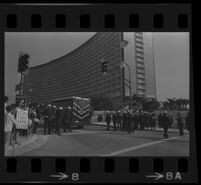 Patrol wagon passes line of police in anticipation of demonstration during President Johnson's visit, 1967