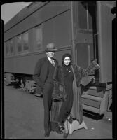 Fay Webb Vallee, wife of bandleader Rudy Vallee, at a train station with her father Clarence Webb, 1933