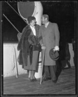 Actors Verree Teasdale and Adolph Menjou on boat deck, 1935-1936