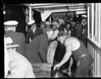 Rescued Wrigley Ocean Marathon swimmer assisted in a boat, 1927