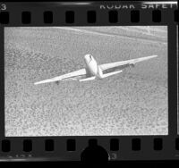 Aerial view of daredevil, "Human Fly" strapped atop a DC-8 at the California National Air Races, 1976