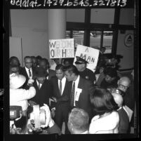 Dr. Martin Luther King being greeted by crowd upon his arrival at Los Angeles airport, 1965