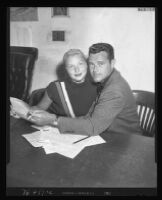 Barbara Payton and Tom Neal apply for passports at the federal building, 1952