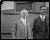 Otto Kahn, investment banker, with an unidentified man, departing at a train station, Los Angeles, 1928