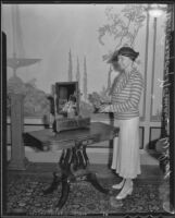 Grace Norman-Wilcox at the Ambassador Hotel holding a piece of crystal, Los Angeles, 1935