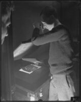 Photographer or technician creating a contact print, Los Angeles, 1935