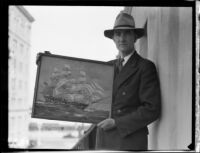 Arthur Beaumont, marine painter, holds a painting of the Constitution, 1933